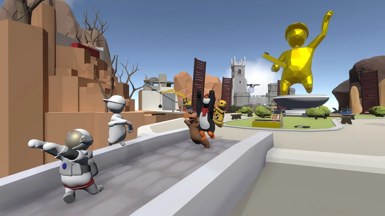 Human Fall Flat castle level showing wobbly ragdoll characters in astronaut and penguin suits climbing stone battlements