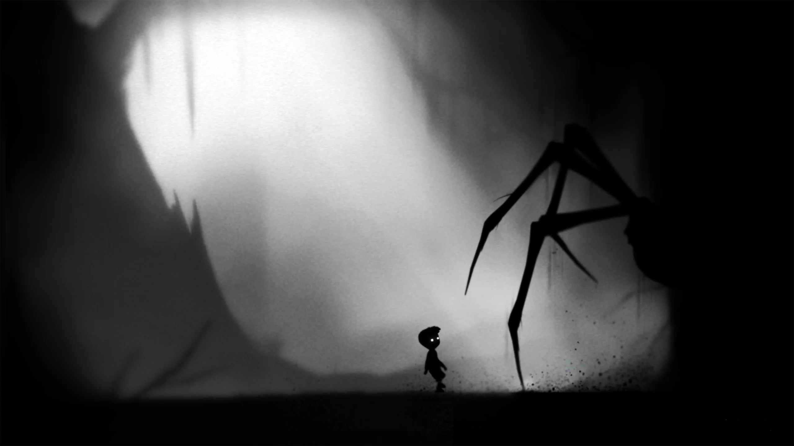 Silhouetted young boy with glowing eyes standing before a giant shadow spider in a dark misty forest